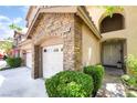 Inviting home exterior boasting stone accents, well-maintained landscaping, and a three-car garage at 259 Rockwell Springs Ct, Henderson, NV 89012