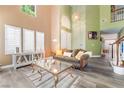 Bright and airy living room with high ceilings, large windows, and modern decor at 259 Rockwell Springs Ct, Henderson, NV 89012