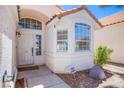 Close-up of the home's entrance, featuring a bay window, front door, and landscaped surroundings at 2752 Devita Cir, Las Vegas, NV 89117