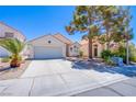 Inviting single-story home with neat landscaping, a two-car garage, and a cozy entrance at 2752 Devita Cir, Las Vegas, NV 89117