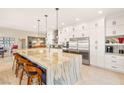Spacious kitchen featuring a large island with seating, modern appliances, and ample cabinet space at 286 Bowsprit Ct, Las Vegas, NV 89183