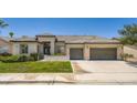 Inviting single-story home showcasing a well-maintained lawn and a three-car garage at 324 Quiet Harbor Dr, Henderson, NV 89052