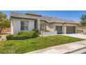 A delightful single-story home with well-kept lawn and a convenient three-car garage at 324 Quiet Harbor Dr, Henderson, NV 89052