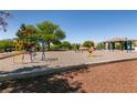 Colorful playground with swings, climbing structures, and gravel safety surface at 4439 Scarlet Sea Ave, North Las Vegas, NV 89031