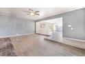 Bright living room with tile flooring, a ceiling fan, an open layout, and light gray walls at 5155 Saratoga Dr, Las Vegas, NV 89120