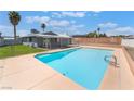 Backyard view showcasing a refreshing pool with ample deck space, lawn, and a covered patio at 5155 Saratoga Dr, Las Vegas, NV 89120