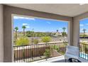 Relaxing balcony view featuring a seating area and a scenic landscape with palm trees at 55 Strada Fontana, Henderson, NV 89011