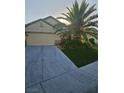 Charming home featuring mature landscaping, a spacious driveway, and a two-car garage at 5717 Blizzard Breeze St, North Las Vegas, NV 89081