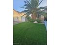 A well-manicured front lawn next to the driveway enhances the curb appeal at 5717 Blizzard Breeze St, North Las Vegas, NV 89081