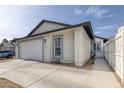 Angle view of house showing two-car garage, walkway and partial fence at 59 N Christy Ln, Las Vegas, NV 89110