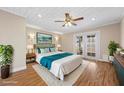 Serene main bedroom with a ceiling fan, French doors, and a soothing color palette at 636 H Ave, Boulder City, NV 89005