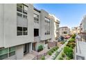 Charming townhome showcasing a light gray exterior with large windows and landscaped front yard at 659 Spotted Falcon St, Las Vegas, NV 89138
