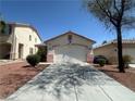 Charming single-story home featuring a two-car garage, desert landscaping, and mature trees at 8042 Palace Monaco Ave, Las Vegas, NV 89117