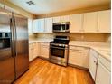 Modern kitchen with stainless steel appliances, white cabinets, and light countertops at 9100 Hombard Ave, Las Vegas, NV 89148