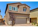 Two-story home featuring a two-car garage and easy-care desert landscaping on a sunny day at 10650 Dryades Ave, Las Vegas, NV 89166