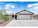Charming single-story home with a well-maintained front yard and a two-car garage at 1105 Winwood St, Las Vegas, NV 89108