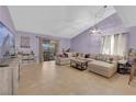 Spacious living room featuring tile floors, a large sectional sofa, and sliding door access at 1105 Winwood St, Las Vegas, NV 89108