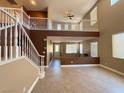 Spacious living room showcasing the staircase, loft, and tile flooring at 1177 Twinkling Meadows Dr, Henderson, NV 89012