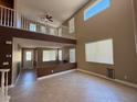 Sunlit living room featuring tile flooring, a loft overlook, and ample natural light at 1177 Twinkling Meadows Dr, Henderson, NV 89012