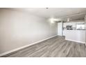 The living room features laminate floors, a view of the kitchen, and neutral walls at 1381 E University Ave # 204, Las Vegas, NV 89119