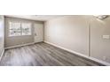 The living area has a front door with modern laminate floors and natural light at 1381 E University Ave # 204, Las Vegas, NV 89119