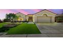 Lovely single-story home featuring an attached two-car garage, desert landscaping, and a pristine front lawn at 2616 Faiss Dr, Las Vegas, NV 89134