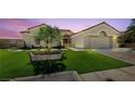 Beautiful single-story home with a manicured lawn and desert landscaping featuring an attached two-car garage at 2616 Faiss Dr, Las Vegas, NV 89134