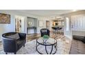 Open-concept living area boasts wood floors and seamless transition into dining area with barstool seating at 3125 N Buffalo Dr # 1133, Las Vegas, NV 89128