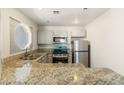 Updated kitchen featuring granite countertops and stainless steel appliances at 5038 S Rainbow Blvd # 206, Las Vegas, NV 89118