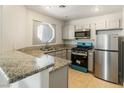 Updated kitchen with granite countertops and stainless steel appliances at 5038 S Rainbow Blvd # 206, Las Vegas, NV 89118