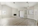 A bright living room featuring wood floors, a fireplace, and multiple windows at 5038 S Rainbow Blvd # 206, Las Vegas, NV 89118