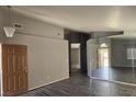 Open-concept living area with tile floors, large mirrors, and view of the front entry at 5121 Backwoodsman Ave, Las Vegas, NV 89130