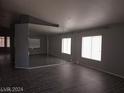 Bright living room featuring tile flooring and a large mirrored wall that enhances the space at 5121 Backwoodsman Ave, Las Vegas, NV 89130