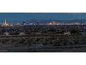 Panoramic view of the Las Vegas skyline at dusk, showcasing the city's vibrant lights and distant mountains at 5234 Savannah Rose St, Las Vegas, NV 89149