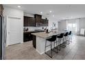 Modern kitchen with a large island, seating, granite countertops, and stainless steel appliances at 5234 Savannah Rose St, Las Vegas, NV 89149