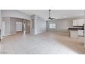 Expansive living room boasts tile floors, arched doorways, and a ceiling fan at 525 Sun Mountain Ave, North Las Vegas, NV 89031