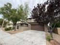 Inviting home with a wide driveway, stone accents, and a well-kept front yard at 5466 Fawn Chase Way, Las Vegas, NV 89135