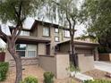 Attractive two-story home with a welcoming facade and manicured landscaping at 5466 Fawn Chase Way, Las Vegas, NV 89135