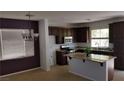 Spacious kitchen with an island, dark cabinetry, and modern appliances at 5466 Fawn Chase Way, Las Vegas, NV 89135