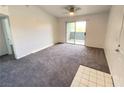 Bright bedroom with neutral carpet, ceiling fan, and sliding door to a balcony at 555 E Silverado Ranch Blvd # 2030, Las Vegas, NV 89183