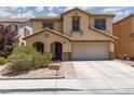 Charming two-story home with a desert landscape, two-car garage and tile roof in a residential neighborhood at 5620 Siena Rose St, North Las Vegas, NV 89031