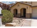 Charming two-story home with a desert landscape, arched entryway and tile roof in a residential neighborhood at 5620 Siena Rose St, North Las Vegas, NV 89031