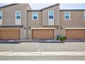 Attached two-car garages for convenient parking and storage, complete with exterior lighting at 668 Tiarella Ln, Henderson, NV 89015