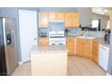 Bright eat-in kitchen featuring wooden cabinetry, stainless-steel appliances, and granite countertops at 7340 Alpine Ridge St, Las Vegas, NV 89131