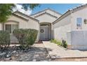 Inviting front entrance with a double door and lovely landscape for increased curb appeal at 7927 Villa Salsa Ave, Las Vegas, NV 89131
