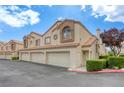 Inviting townhome featuring a two-car garage and a cozy entryway at 8301 Boseck Dr # 232, Las Vegas, NV 89145