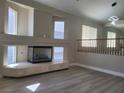 Spacious living room features a fireplace with marble hearth and open floor plan with light wood flooring at 9556 Ancala Hollow Ct, Las Vegas, NV 89148
