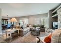 Open-concept living room featuring a large sectional sofa, neutral tones, and ample natural light at 10809 Garden Mist Dr # 1042, Las Vegas, NV 89135