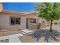 Inviting exterior view of home with rock landscaping, enhancing curb appeal and natural charm at 2050 N Los Feliz St # 171, Las Vegas, NV 89156