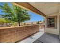 Outdoor patio featuring a brick wall and views of nearby houses, providing a relaxing space at 2050 N Los Feliz St # 171, Las Vegas, NV 89156
